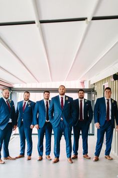 a group of men in suits standing next to each other