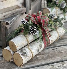 some logs are decorated with pine cones and plaid bows