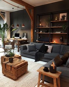 a living room filled with furniture and a wooden table in front of a book shelf