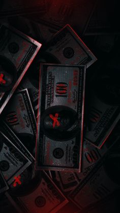 several stacks of money with red crosses on them