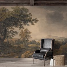 a chair sitting in front of a wall with a painting on it's side