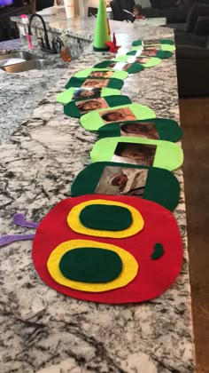 a long table with pictures on it in the shape of caterpillars and circles