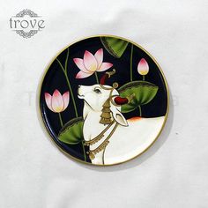 a plate with a painting of a white horse and pink flowers on it's side