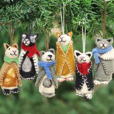 a group of ornaments hanging from a christmas tree in the shape of cats and bears