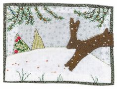 an embroidered christmas card with a tree and snow covered ground in front of evergreens