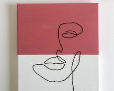 a pink and white canvas with a black line drawing of a woman's face