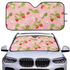 the front and back of a car with flowers and strawberries printed on it's windshield