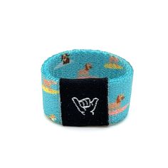 "For all of us dog lovers out there, Surf Pups illustrates man's best friend catching some super chill waves. One size Fits fingers size 6 to 8. 1/2\" Width Reversible surf and beachy prints. Elastic blend material. Packaged in natural drawstring gift pouches. Machine washable. Chlorine and saltwater safe." Beachy Prints, Surf Accessories, Hang Loose, Thumb Rings, Mans Best Friend, Ring Designs, Band Rings, Dog Lovers, Surfing