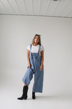 Frankie Denim Overalls are crafted from washed denim for a stylish, weathered look. Featuring an oversized and loose fit with adjustable straps and distressed details, these overalls are designed to provide a comfortable, personalized fit. Model Measurements: Hips 34” Waist 25” Bust 32” Height 5’6.5, wearing a size small Material: 100 Cotton Measurements XS: Hips: 42"| Length: 44" (taken from top of front of overalls to ankle cuff) S: Hips: 42"| Length: 44.5" (taken from top of front of overalls Bridesmaid Tops, Washed Denim, Denim Overalls, Man Swimming, Romper Pants, New Arrival Dress, Trending Dresses, To Miss, Denim Wash