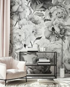 a white chair in front of a floral wallpaper