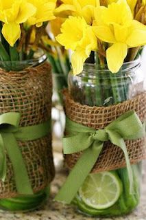 two mason jars with lemons and daffodils tied to burlap