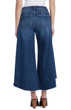 Pronounced distressing dances along the hem of these sweeping gaucho jeans cut from stretch-kissed denim with a heavily sanded finish. 24" inseam; 28" leg opening; 10 1/4" front rise 66% cotton, 22% REPREVE® recycled polyester, 8% polyester, 3% rayon, 1% spandex REPREVE recycled polyester is made from 100% post-consumer recycled plastic bottles Machine wash, tumble dry Imported Spring Dark Wash Washed Flare Jeans, Chic Medium Wash Flare Jeans With Frayed Hem, Faded Cropped Leg Flare Jeans For Fall, Chic Denim Blue Flare Jeans With Frayed Hem, Wide Leg Flare Jeans With Frayed Hem For Fall, Fall Wide Leg Cropped Jeans With Frayed Hem, Fall Flare Jeans With Frayed Hem And Wide Leg, Wide Leg Cropped Jeans With Frayed Hem For Fall, Denim Blue Flare Cropped Jeans With Frayed Hem