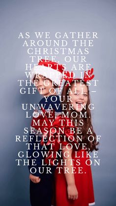 two children wearing christmas hats and standing next to each other in front of a blue background