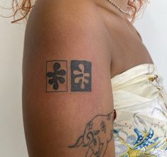 a woman with a tattoo on her arm that has an elephant and cross in it