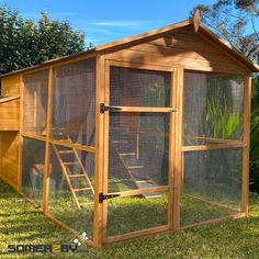 a chicken coop in the middle of some grass