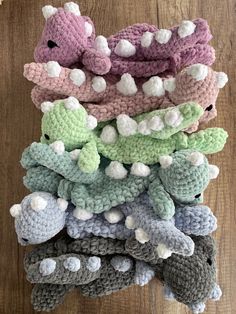 a pile of crocheted stuffed animals sitting on top of a wooden floor