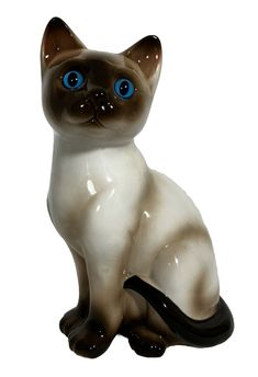 a white and brown cat figurine with blue eyes