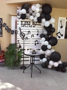 black and white balloon arch with musical notes