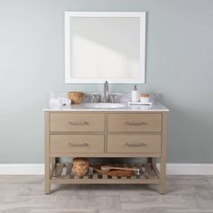 a bathroom vanity with two sinks and a large mirror above it on top of a wooden floor