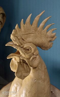 a statue of a chicken with its mouth open