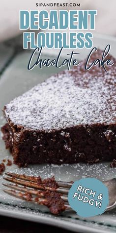 a piece of chocolate cake with powdered sugar on top and a fork next to it