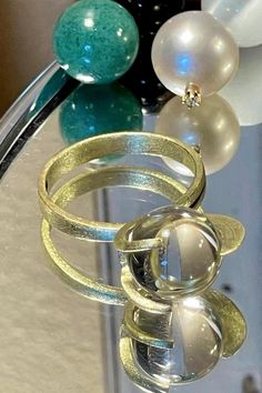 Rare 14k BRUTALIST MODERNIST POOLS OF LIGHT ROCK CRYSTAL GLASS ORB Ring!  in excellent condition! arrives in jewelry case and can be gifted immediately! crafted in solid 14k yellow gold and comes with 10 different gemstone spheres - each approx 10mm. there are natural gem orbs:  -moonstone with blue sheen (the moonstone is approx 7.55Ct please see photo for its carat weight), -South Sea Pearl wit diamond, -agate - eye like pattern( please see photos),  -lapis,  - golden sand stone,  -amethyst, Modern Yellow Gold Round Moonstone Ring, Modern 14k Gold Round Moonstone Ring, Gold Moonstone Ring In 14k Gold, Modern Gold Crystal Ring With Gemstone, Modern Gold Oval Crystal Ring, Modern Gold Moonstone Rings, Modern Gold Crystal Ring Gift, Modern Gold Crystal Ring For Gift, Modern Round Moonstone Rings