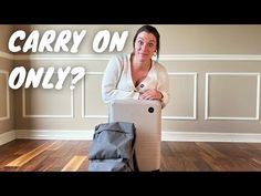 a woman sitting on top of a suitcase with the words, carry on only?