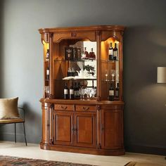 a large wooden china cabinet with wine glasses on it's glass doors and shelves