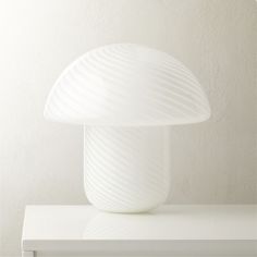 a white lamp sitting on top of a table