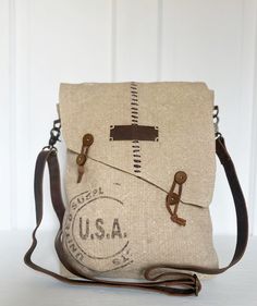 "*This vintage style bag is made with upcycled woven canvas giving a burlap look *Genuine leather adjustable shoulder strap *Asymmetrical front flap with unique stitching and string closures (no zipper) *13\" H x 11\" W x 2\"D *One interior zipper pocket and two slip pockets   *Due to the upcycled nature of materials there may be some stiching irregularities, this is what give the bag its unique vintage vibe!" Vintage Canvas Crossbody Satchel, Upcycled Canvas Satchel Shoulder Bag, Vintage Canvas-lined Crossbody Shoulder Bag, Upcycled Canvas Crossbody Bag, Vintage Upcycled Canvas Travel Bag, Vintage Canvas Bags, Myra Bags, Carpet Bags, Vintage Style Bag