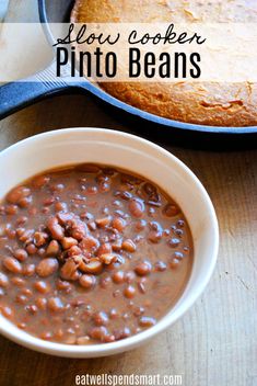 a bowl of baked beans next to a skillet with the words slow cooker pinto beans