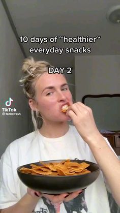 a woman is eating some food in front of her face and the caption reads, 10 days of healthier everyday snacks day 2