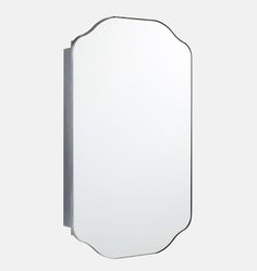 a mirror that is on the wall in front of a white background with black trim