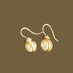 Elevate any look with our Hand Wrapped Swarovski Pearl Earrings. Perfect for brides and bridesmaids, these drop earrings blend simple gold with timeless elegance. Ideal for special occasions or everyday wear, they make a thoughtful gift. Capture the essence of sophistication with these stunning earrings. Formal Round Wire Wrapped Jewelry, Elegant Pierced Wrap Earrings For Wedding, Elegant Adjustable Wrap Earrings As Gift, Gold Wire Wrapped Earrings For Wedding, Adjustable Wrap Earrings For Wedding, Elegant Adjustable White Wrap Earrings, Elegant White Adjustable Wrap Earrings, Adjustable Gold Wrap Earrings For Wedding, Elegant Nickel-free Wrap Earrings For Gift