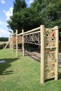 a wooden climbing wall in the grass