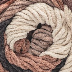 several different colored rugs stacked together on top of each other in a spiral pattern