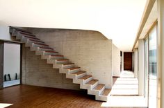 an empty room with stairs leading up to the second floor