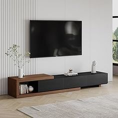 a large flat screen tv mounted to the side of a wall in a living room