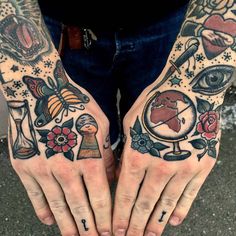 two hands with different tattoos on them and one has an eye in the middle, while the