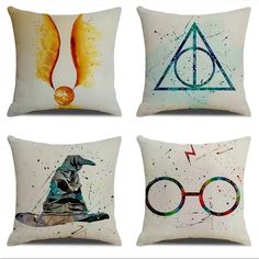 four pillows with harry potter symbols painted on the front and back, all in different colors