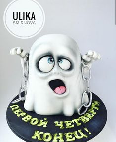 there is a cake that looks like a ghost with chains around it's neck