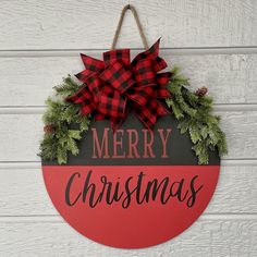 a merry christmas sign hanging on the side of a building