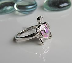 Lab Pink Opal ring - Opal turtle silver ring - Turtle ring - womens silver ring - cute ring - turtle lover Some sizes are sold out. But will be replenished shortly Height of ring is 16.7mm and width is 14.4 Band width 2.4mm and shank is 2.4mm This is a Lab Opal created stone in an inlay setting High Polished, solid 925 sterling silver. Rhodium plated to prevent tarnishing. TARNISH FREE Rhodium plated to avoid tarnishing Nothing but the best from my custom jewelry store. If it doesnt fit, you hav Sterling Silver Turtle-shaped Rings, Silver Turtle Jewelry, Pink Opal Ring, Turtle Ring, Star Labs, Cute Ring, Vero Beach Fl, Ring Opal, Vero Beach