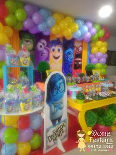 the inside of a birthday party with balloons and decorations on display in front of it