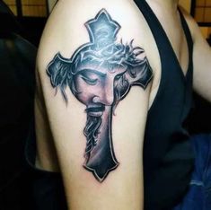 a woman with a cross tattoo on her shoulder