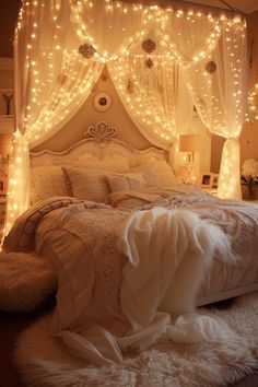 a white bed with lights on the headboard and curtains over it's head