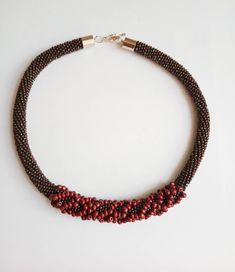 The burgundy necklace is handmade work . Necklace made of Czech beads, jeans tread. The crochet necklace is elegant and stylish jewelry for women. The size of necklace: *19.6 inches (50cm) ###Shipping#### *North America-15-25 days, *Europe-10-20 days ### Care instructions ### Simple advice which help you care for your beaded necklace: 1) Better not to bend and twist necklace. Best to store it in a separate envelope or casket away from sunlight and moisture. 2) Try to avoid getting water, perfume, hairspray on beads and natural stone. 3) To clean your necklace, wipe with a piece of soft, dry cloth, but do not use cleaning, detergents and other aggressive substances. Do not wash it in the washing machine or use chemical cleaning. Handmade Burgundy Beaded Necklaces As Gift, Handmade Burgundy Beaded Necklaces For Gifts, Handmade Burgundy Necklaces With Round Beads, Burgundy Necklace, Blue Choker, Beadwork Necklace, Crochet Rope, Necklace Elegant, Beaded Rope