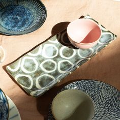 a table topped with plates and bowls on top of a cloth covered tablecloth next to an egg