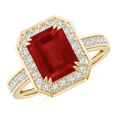 an engagement ring with a red stone surrounded by diamonds