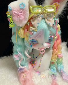 a close up of a doll with pastel hair and eyeglasses on it